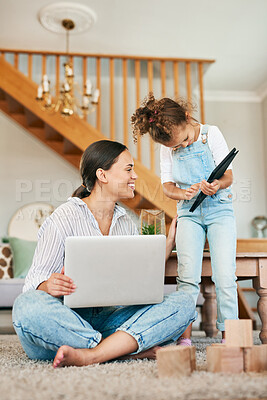 Buy stock photo Shot of a mother and her little daughter using digital devices at home