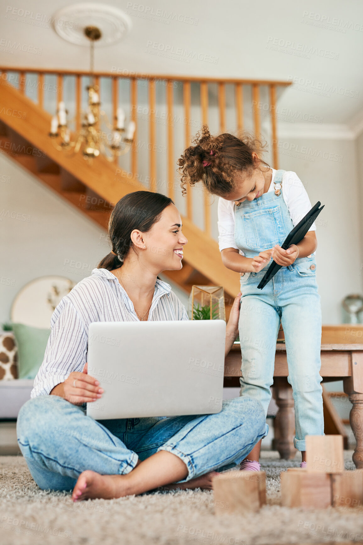 Buy stock photo Shot of a mother and her little daughter using digital devices at home