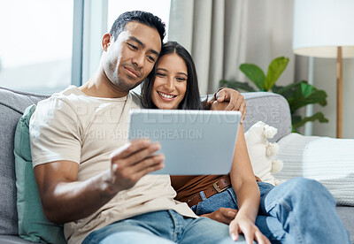 Buy stock photo Happy couple, tablet and watching on sofa for online streaming, entertainment or social media at home. Man and woman smile and sitting in living room for technology, connection or networking at house