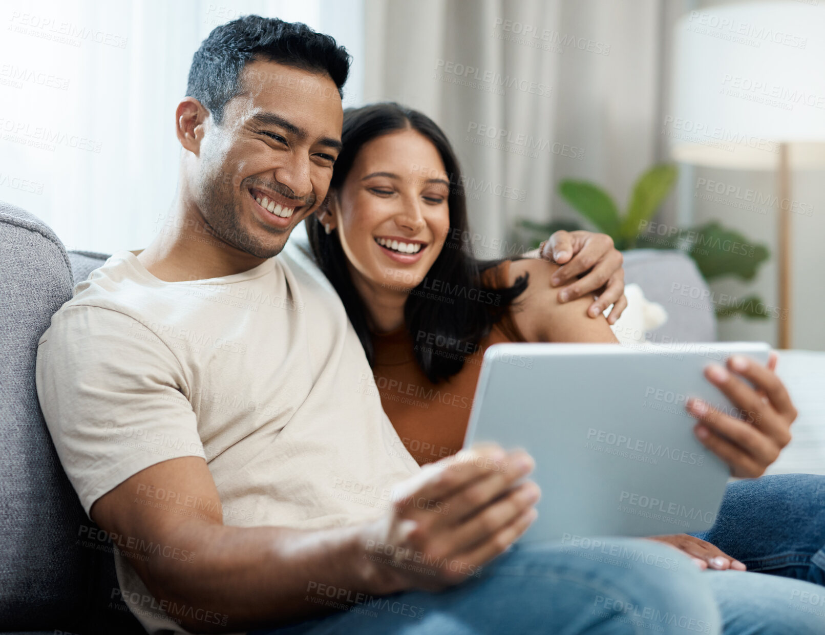 Buy stock photo Happy couple, tablet and relax on sofa for entertainment, online streaming or social media at home. Man and woman sitting in living room with smile for technology, connection or networking at house