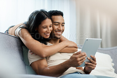 Buy stock photo Happy, love and couple hug with tablet on sofa for social media, movies or streaming film at home. Support, smile or people in living room with digital, search or app for show, video or communication