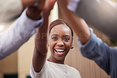 Buy stock photo Shot of a young businesswoman high fiving her work colleagues