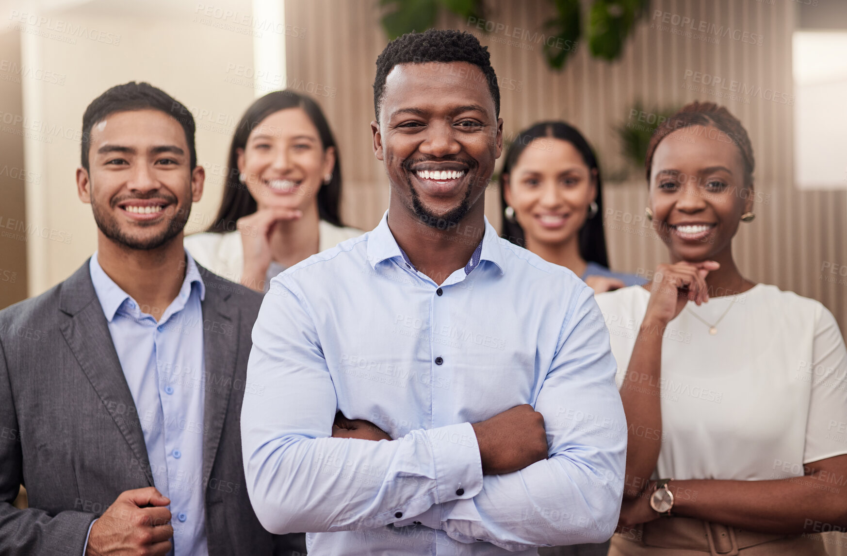 Buy stock photo Shot of a team of businesspeople together in their office with their arms crossed