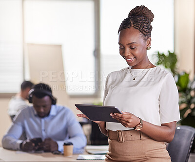 Buy stock photo Shot of a young businesswoman using her digital tablet