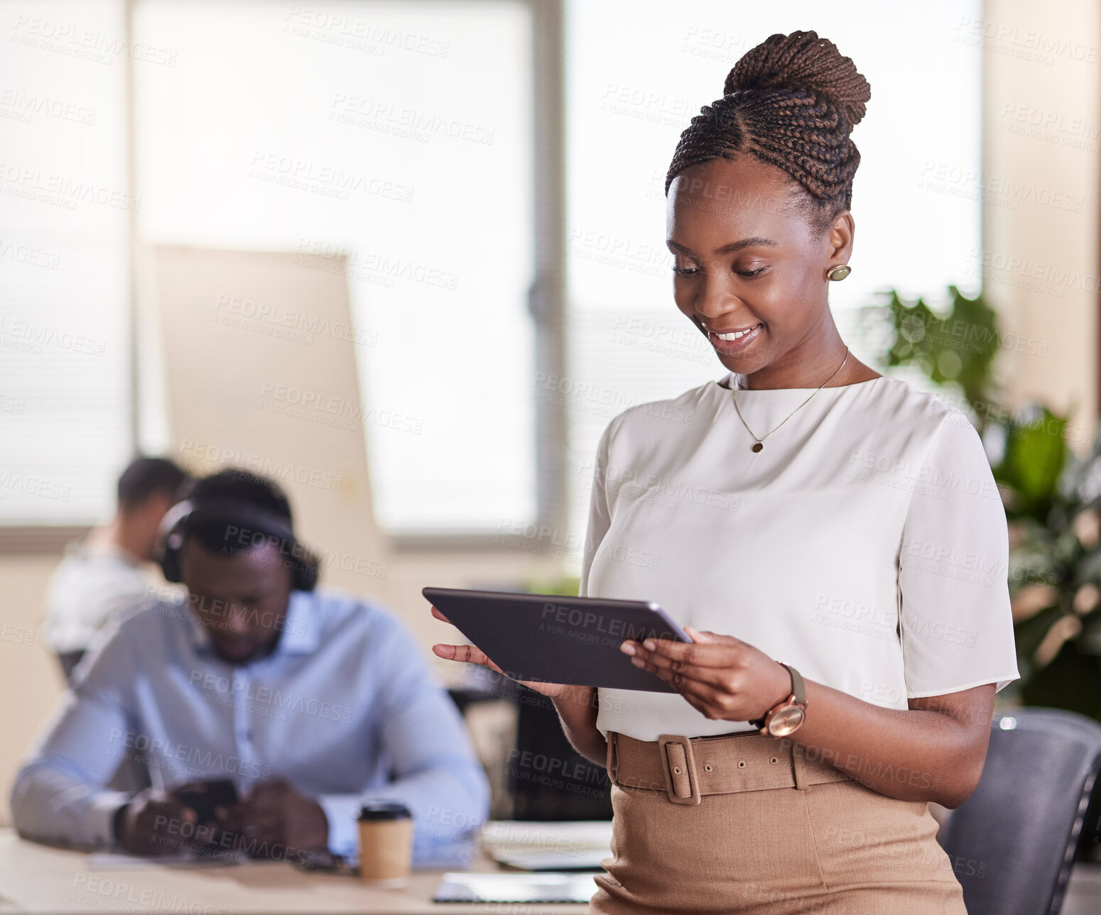 Buy stock photo Shot of a young businesswoman using her digital tablet