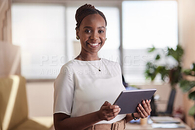 Buy stock photo Shot of a young businesswoman using her digital tablet