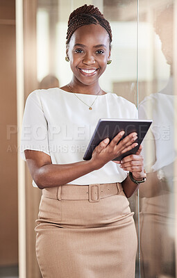Buy stock photo Shot of a young businesswoman using her digital tablet at work