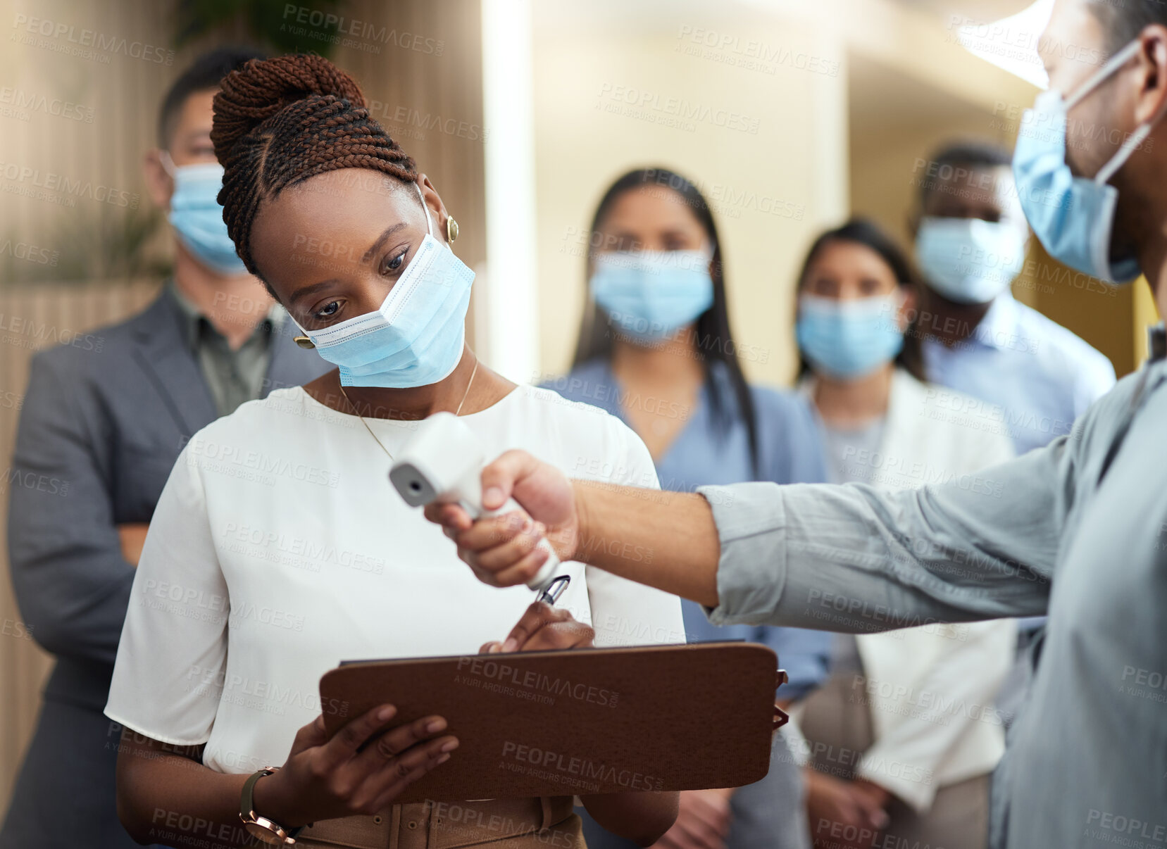 Buy stock photo Cropped shot of an attractive young businesswoman wearing a mask and going through covid screen while standing at the head of a queue in her office