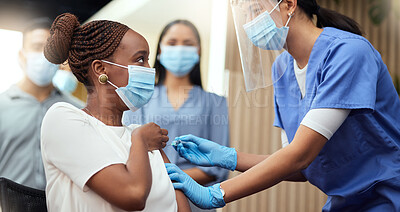 Buy stock photo Cropped shot of an attractive young businesswoman getting her covid vaccination from a female nurse in the office
