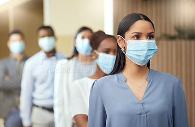 Buy stock photo Cropped shot of an attractive young businesswoman wearing a mask while standing at the head of a queue in her office