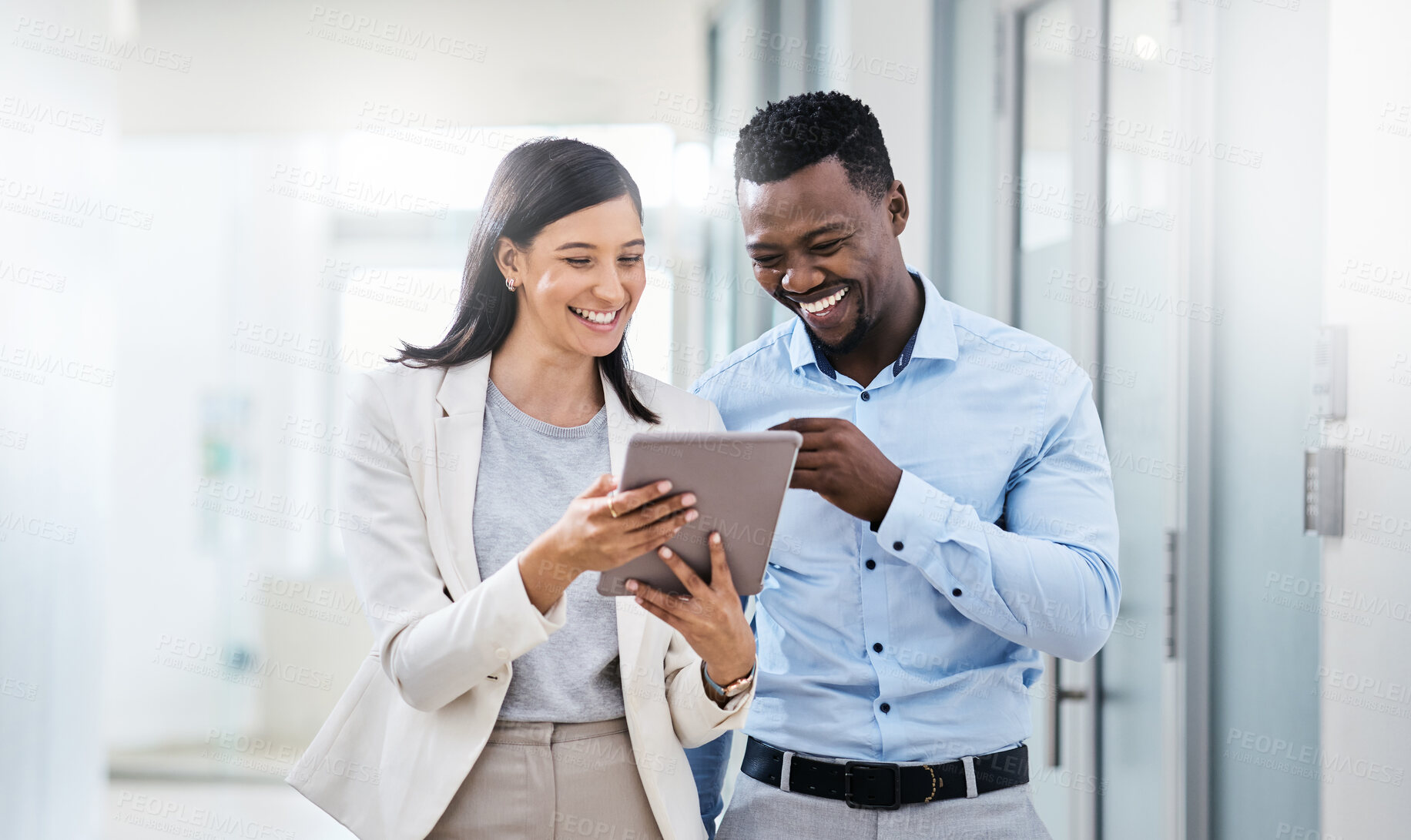 Buy stock photo Shot of two businesspeople discussing something on a digital tablet