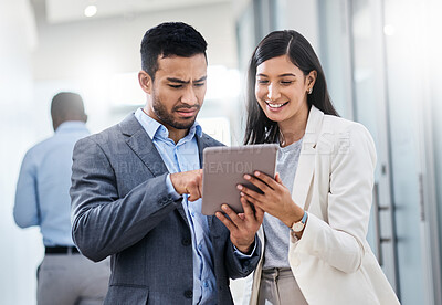 Buy stock photo Shot of two businesspeople discussing something on a digital tablet