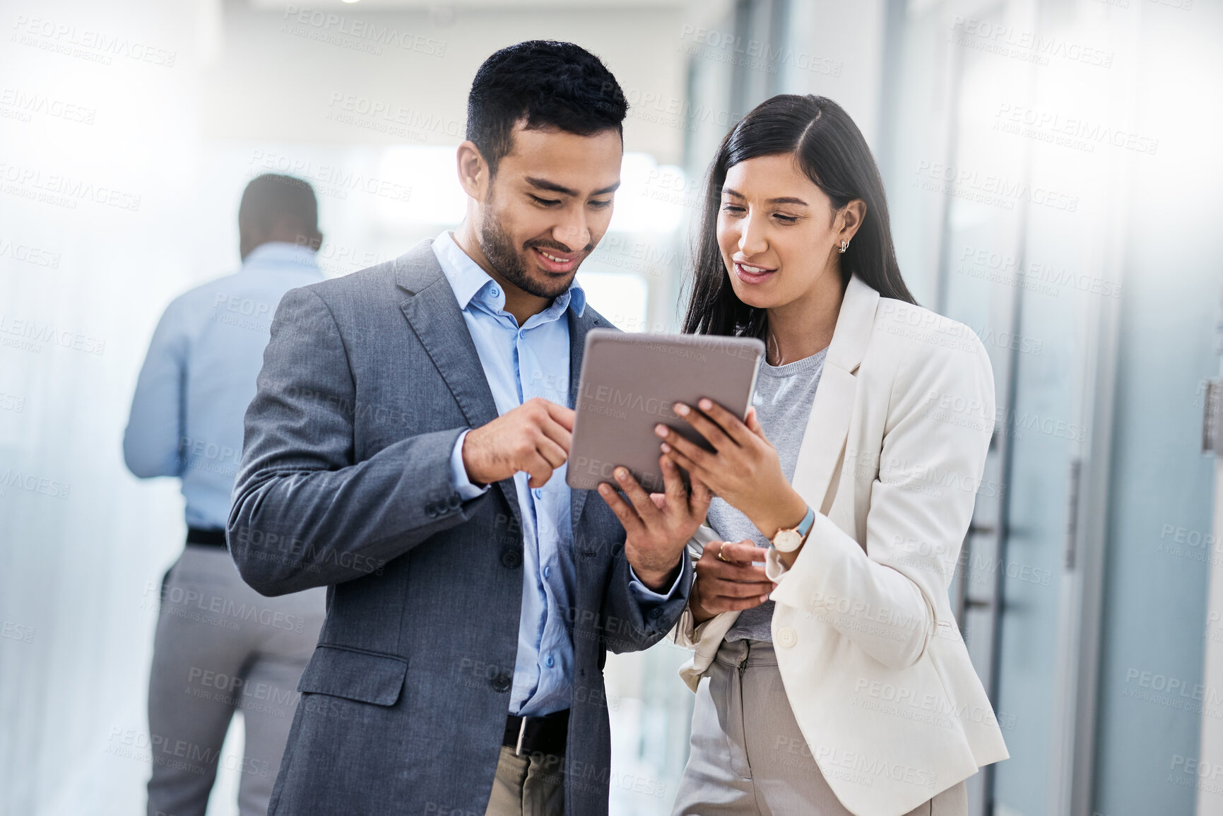 Buy stock photo Shot of two businesspeople discussing something on a digital tablet