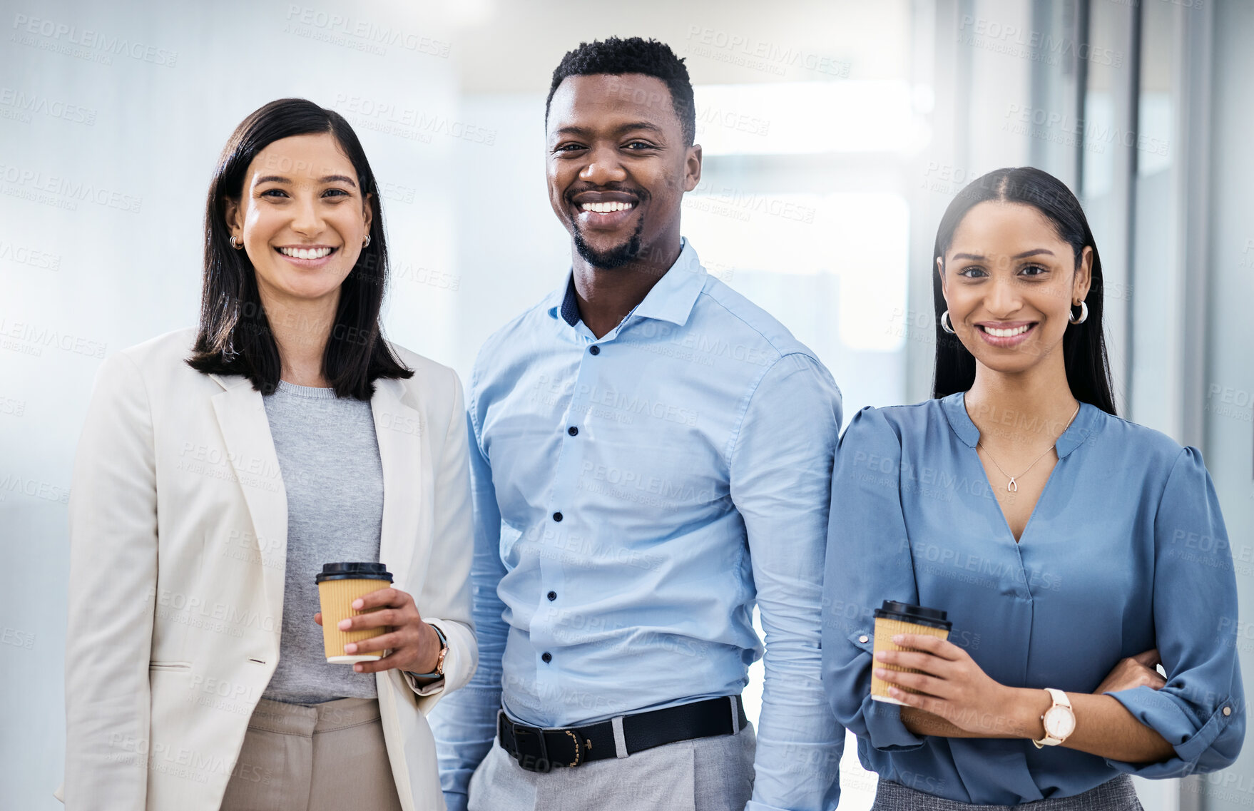 Buy stock photo Shot of three young businesspeople standing together in an office