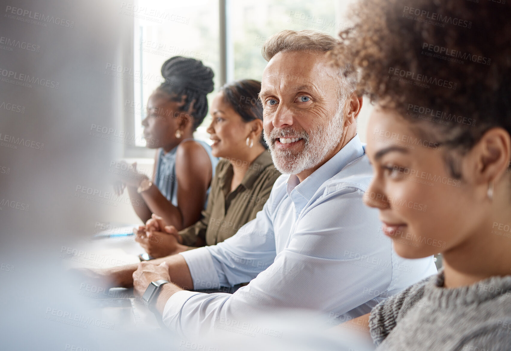 Buy stock photo Shot of a group of businesspeople in a meeting at work