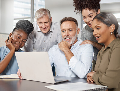Buy stock photo Shot of a group of businesspeople using a laptop at work