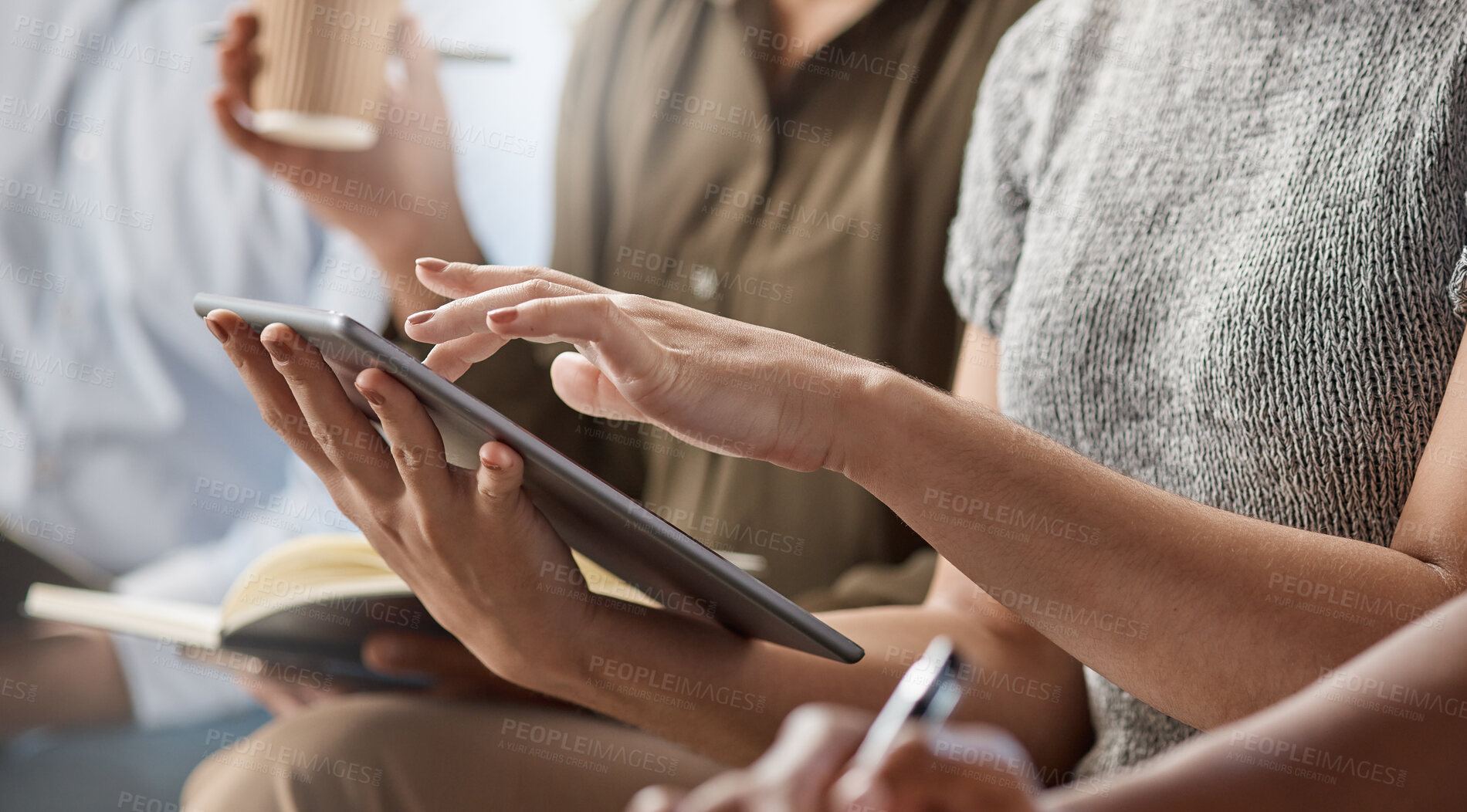 Buy stock photo Shot of an unrecognizable businessperson using a digital tablet at work