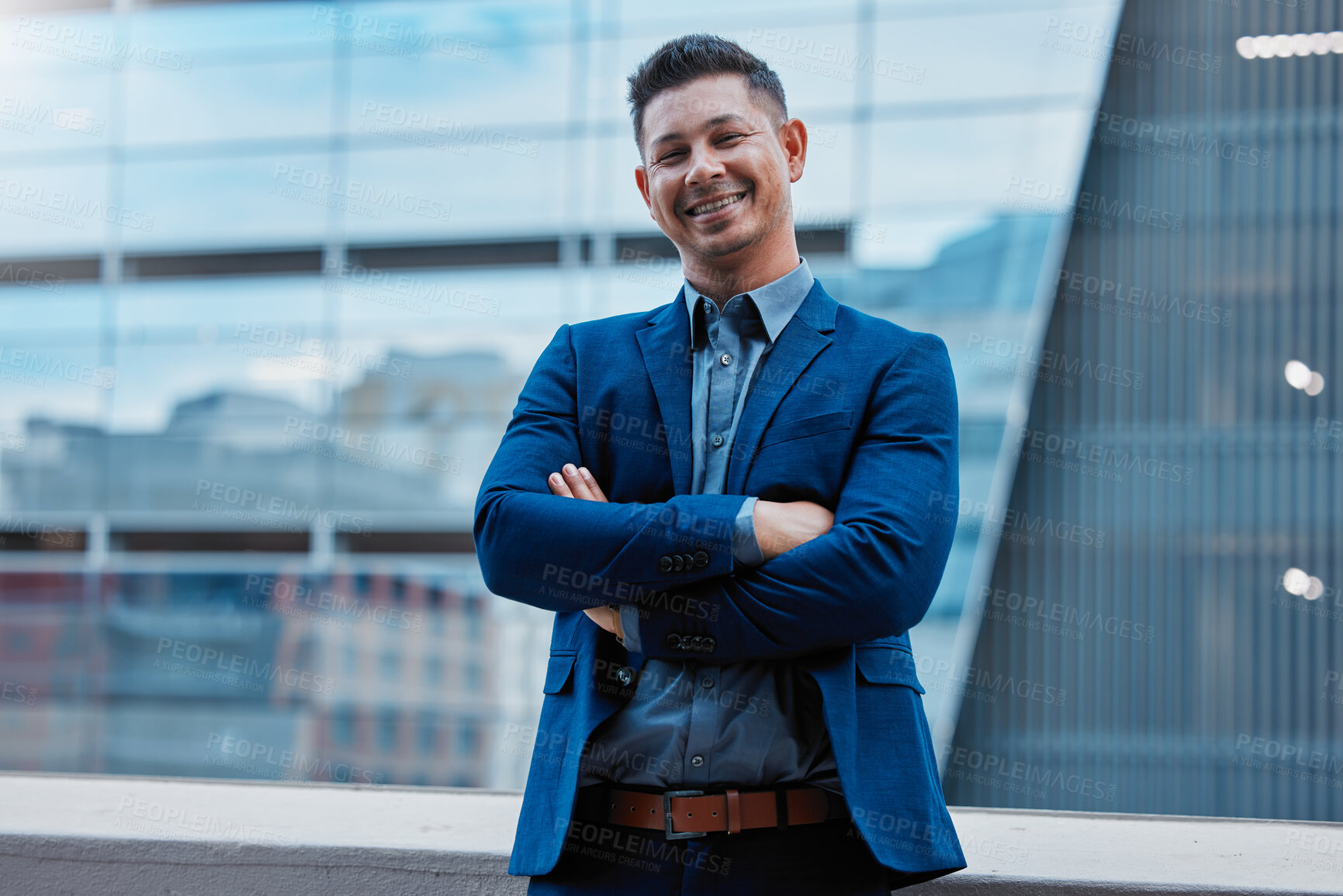 Buy stock photo Cropped portrait of a handsome mature businessman standing with his arms folded outside on the office balcony