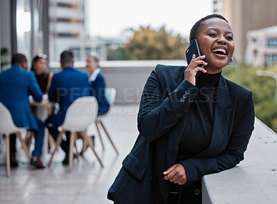 Buy stock photo Cropped shot of an attractive young businesswoman making a phonecall while standing outside on the office balcony