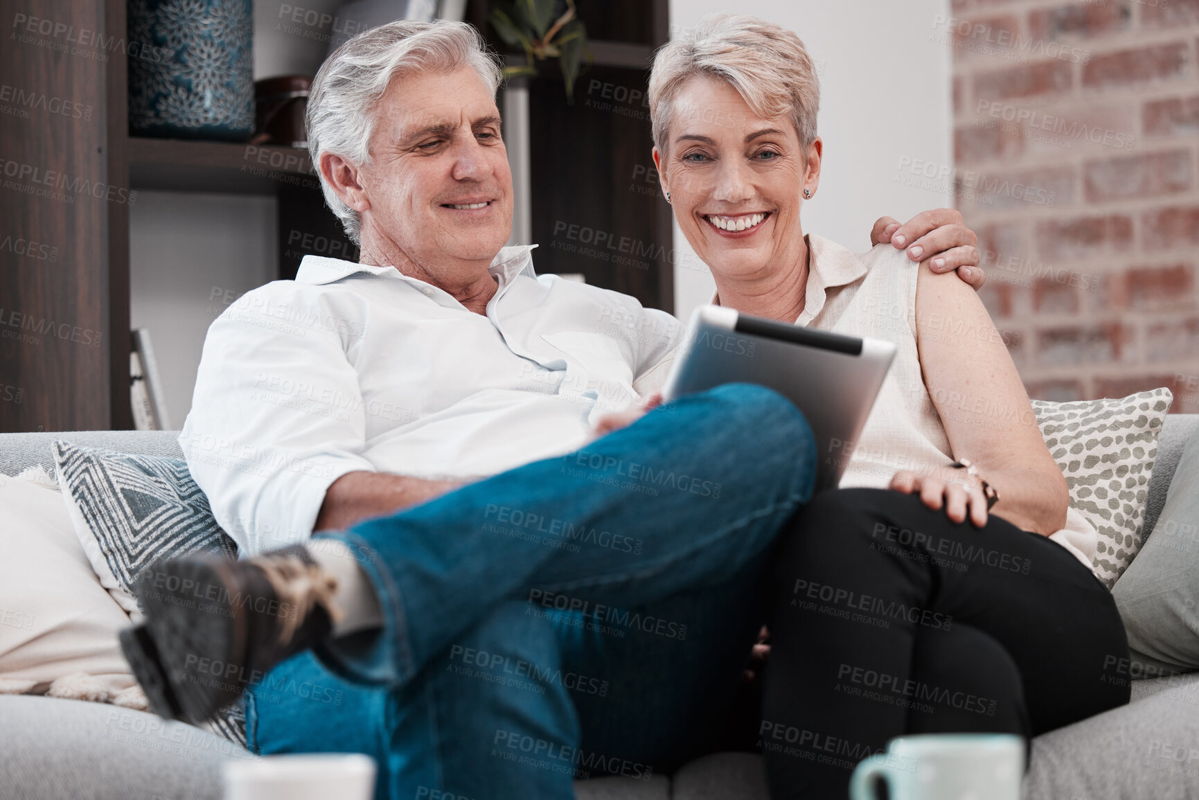 Buy stock photo Happy, tablet and mature couple in portrait or home for reading on social media for election news. Streaming subscription, hug or man with woman with technology, internet or smile to relax in Canada