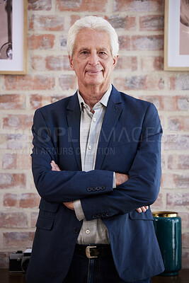 Buy stock photo Shot of a senior businessman standing with his arms crossed at work