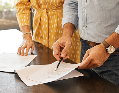 Buy stock photo Shot of two unrecognizable people going through paperwork