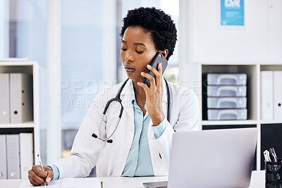 Buy stock photo Cropped shot of an attractive young female doctor taking notes while making a phonecall in her office