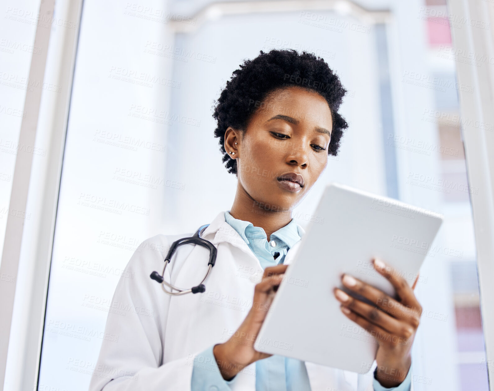 Buy stock photo Tablet, black woman or doctor with stethoscope in hospital for results, research and medical advice. Technology, female person or healthcare worker in clinic for patient care and online appointment