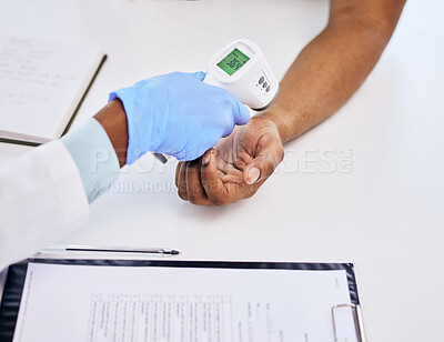 Buy stock photo High angle shot of an unrecognizable patient having his temperature taken by the doctor during a consult