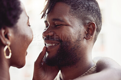 Buy stock photo Shot of a young man bonding with his girlfriend outdoors