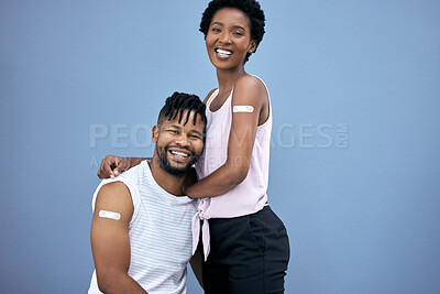 Buy stock photo Shot of a young couple posing together in the studio after getting their Covid vaccines