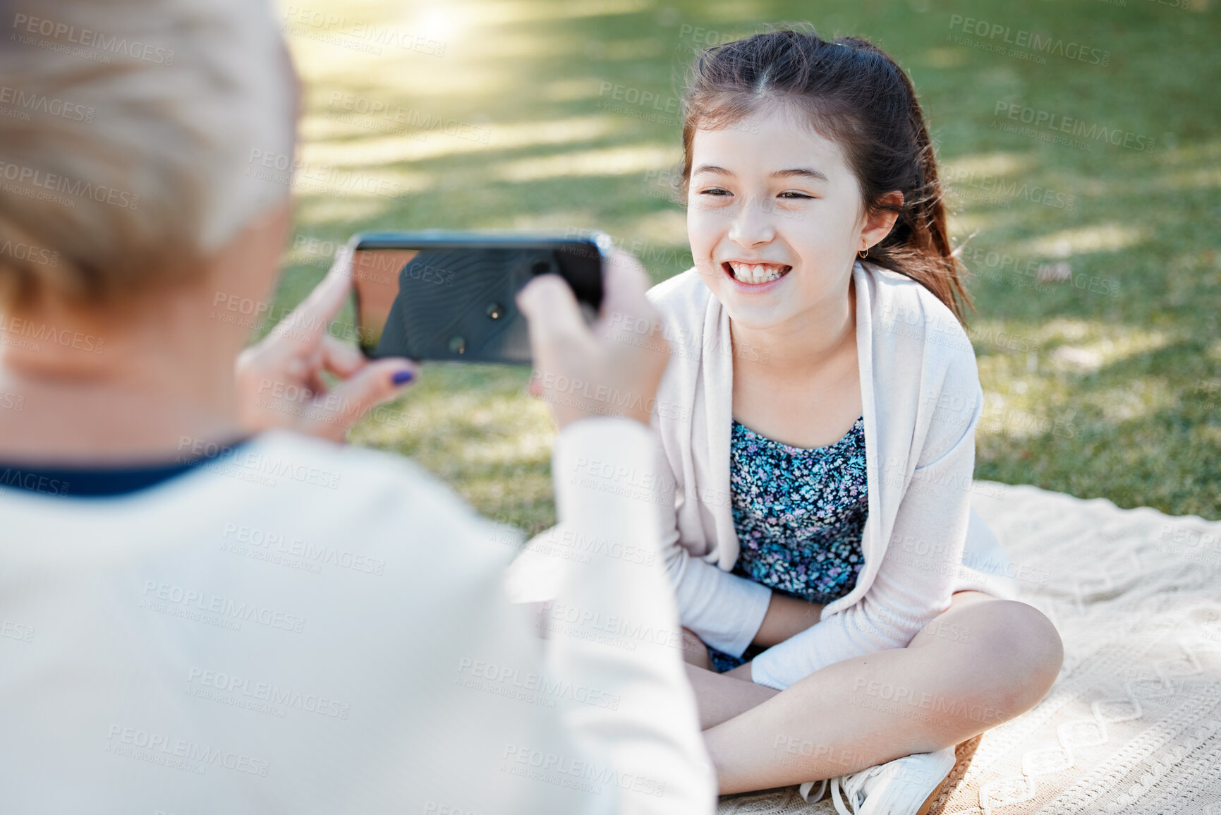 Buy stock photo Outdoor, girl and grandmother with smartphone, picture and sunshine with weekend break, vacation and smile. Family, granny and grandchild with happiness, cellphone and mobile user with memory and kid