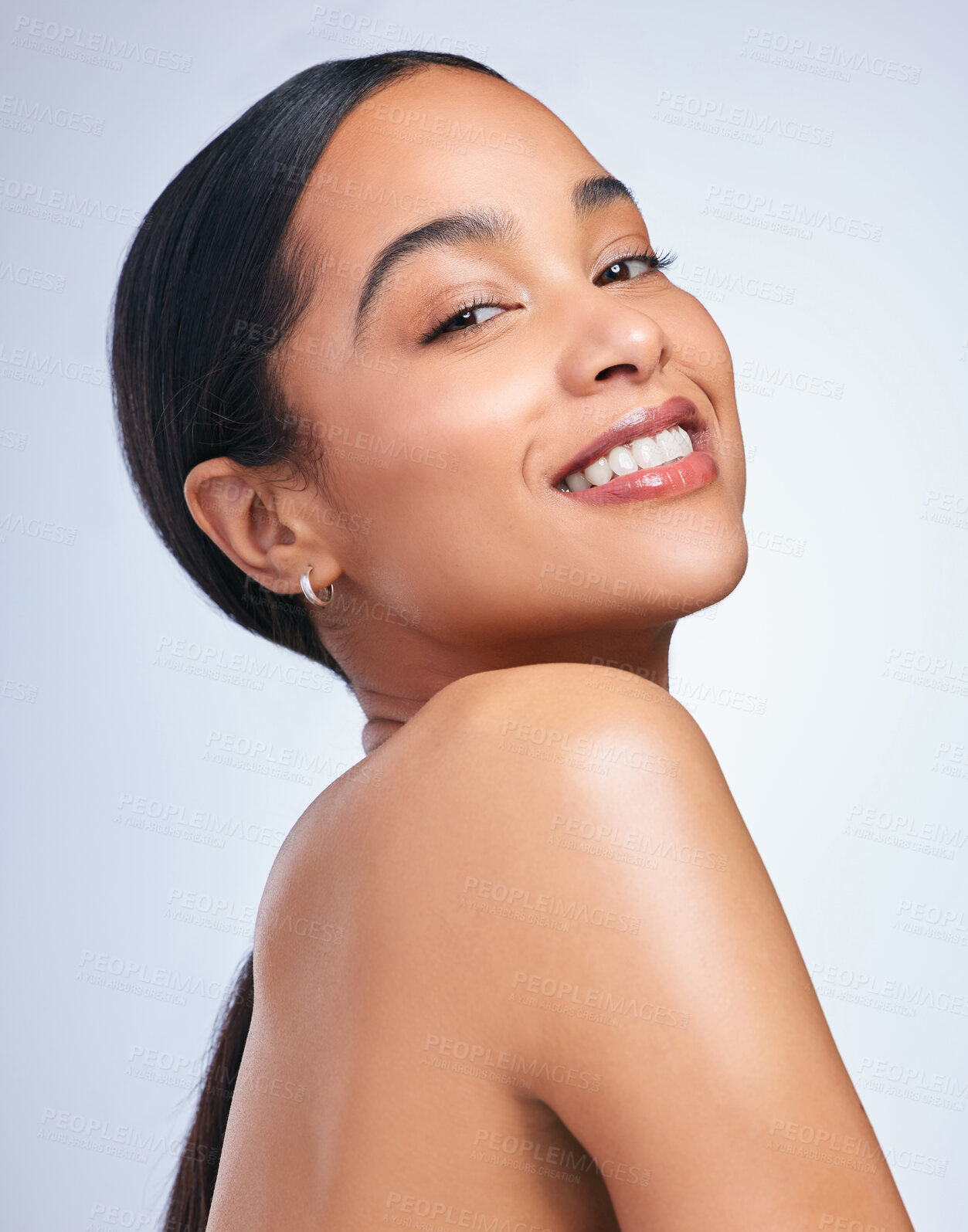 Buy stock photo Shot of a beautiful young woman posing against a grey background