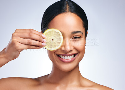 Buy stock photo Woman, skincare and lemon in studio portrait with smile, happiness or natural glow on skin by white background. Girl, model and happy for fruit, cosmetics or youth with wellness, nutrition and shine