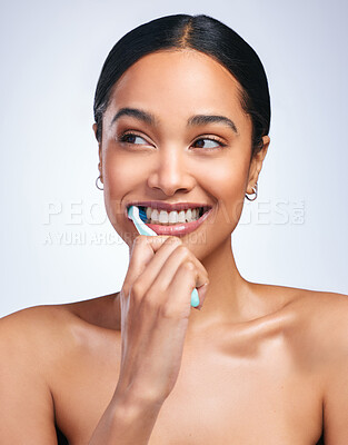 Buy stock photo Woman, brushing teeth and studio with thinking, smile or self care for dental wellness, health or white background. Girl, dentistry model and toothbrush with toothpaste, product or happy for cleaning