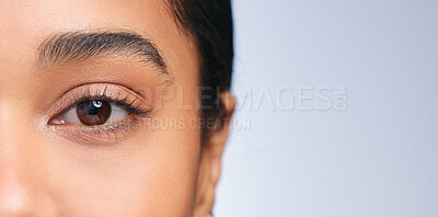 Buy stock photo Cropped portrait of a beautiful young woman posing against a blue background