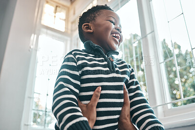 Buy stock photo Shot of a young boy enjoying himself at home