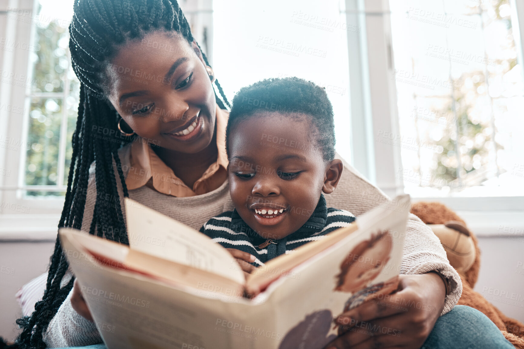 Buy stock photo African woman, child and book for learning, education and reading on bed for development and relax with smile. Mother, young boy and happiness in family home for study and story telling with love