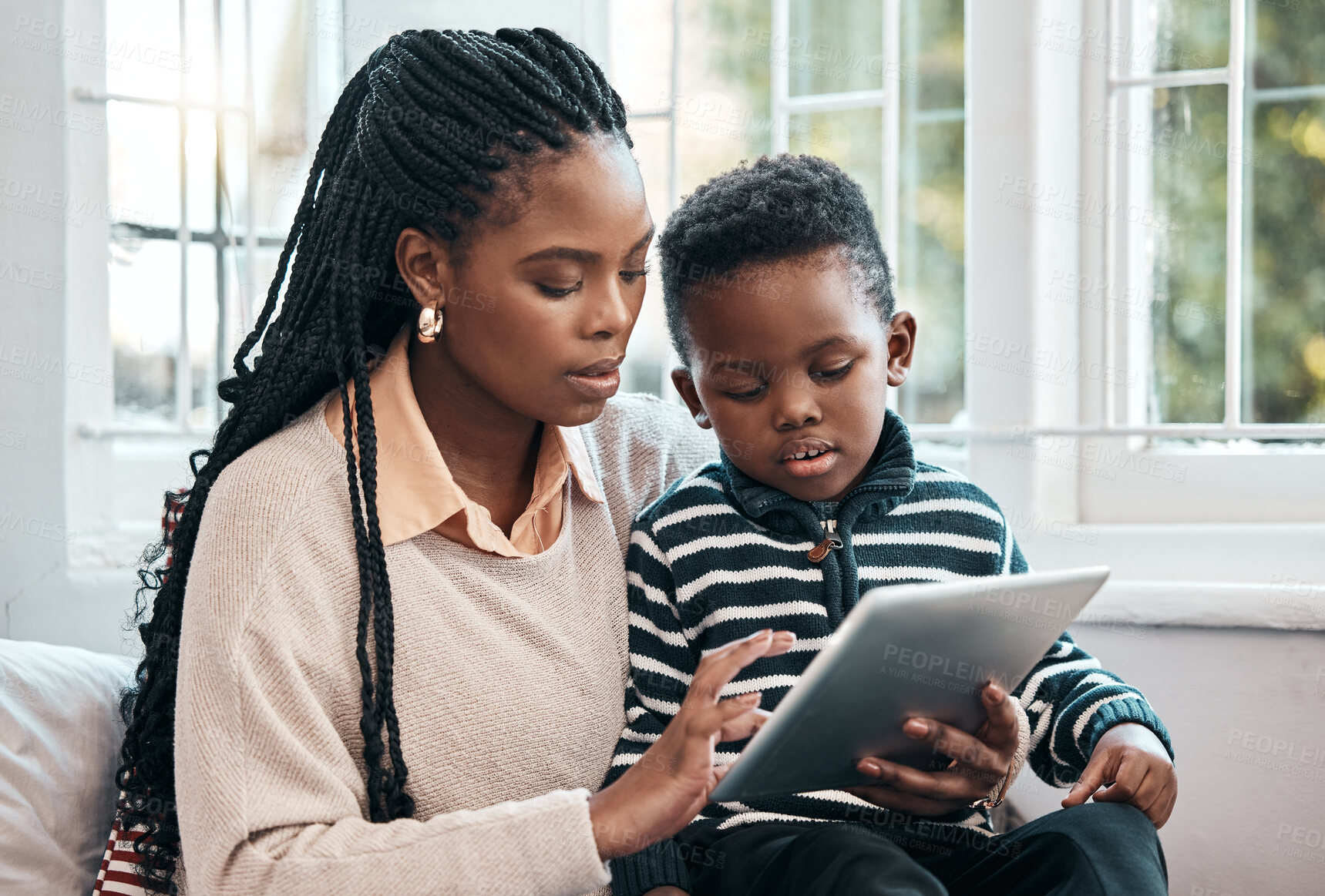 Buy stock photo Child, African woman and tablet for elearning, education and gaming on bed for development and connection. Mother, young boy and technology in family home for online streaming and social media
