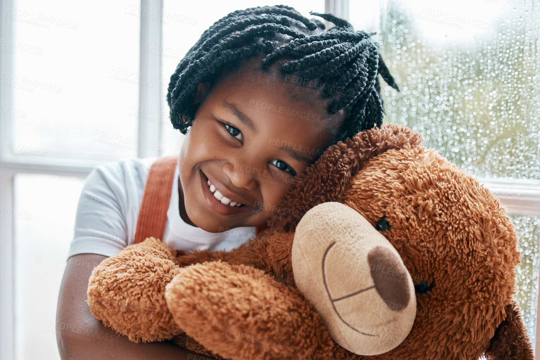Buy stock photo Portrait of an adorable little girl holding a teddy bear at home