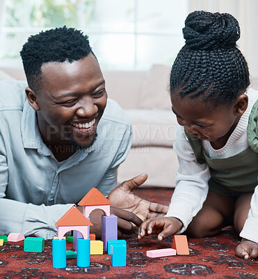 Buy stock photo Shot of a father and his daughter playing with wooden blocks together at home