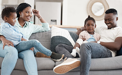 Buy stock photo Cropped shot of an affectionate young family of four relaxing in the living room at home
