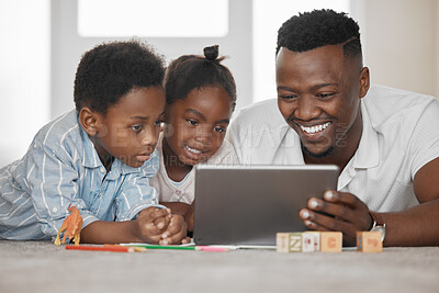 Buy stock photo Shot of a father using a digital tablet with his son and daughter at home