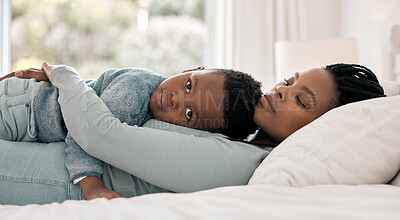 Buy stock photo Cropped portrait of an adorable little boy lying on his mother's chest on a bedroom at home