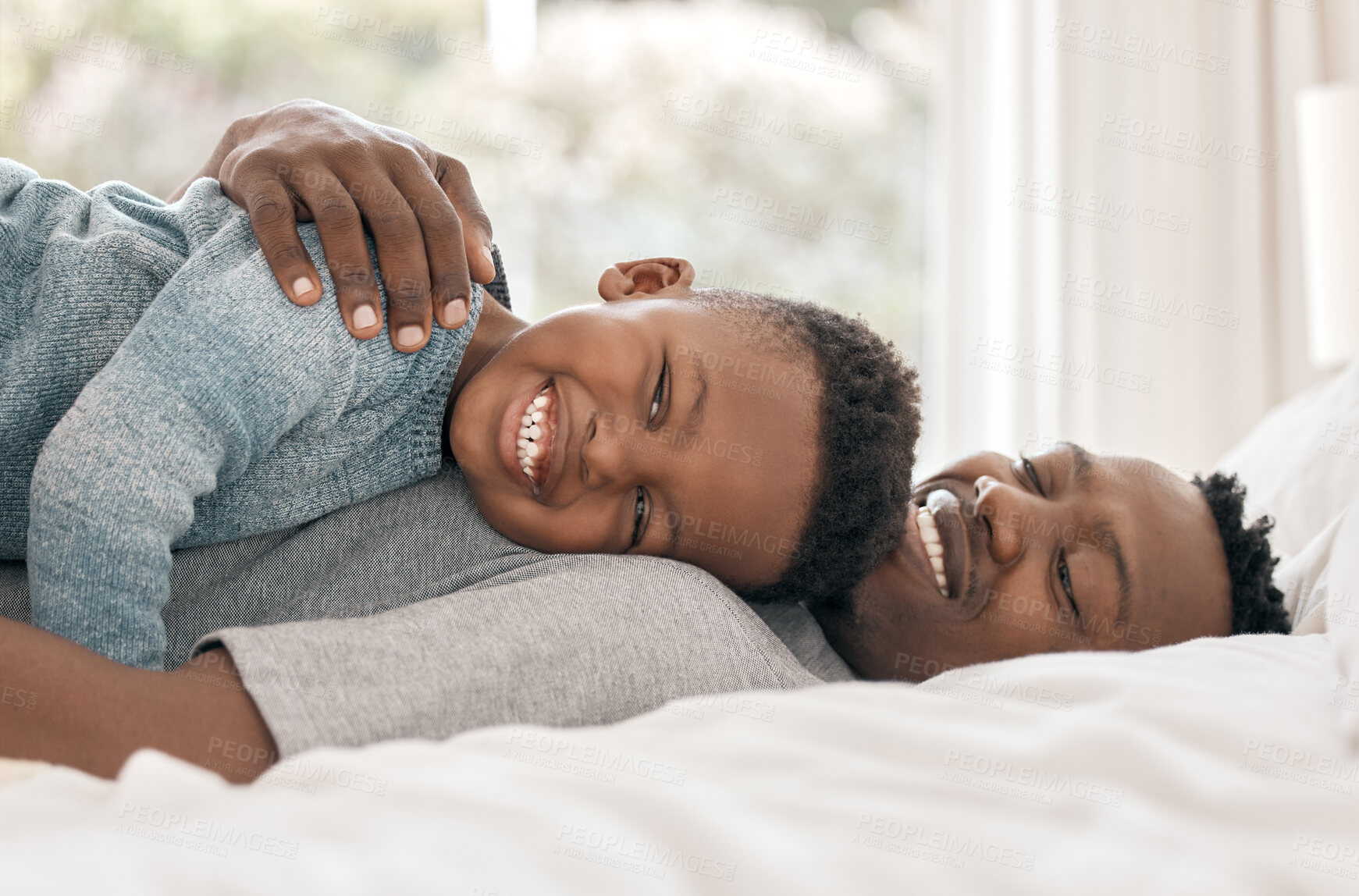 Buy stock photo Portrait, boy and father in bed with hug, support and childhood development for love and affection. Black man, son and bonding in happy, together for care as family on weekend for memory or emotion