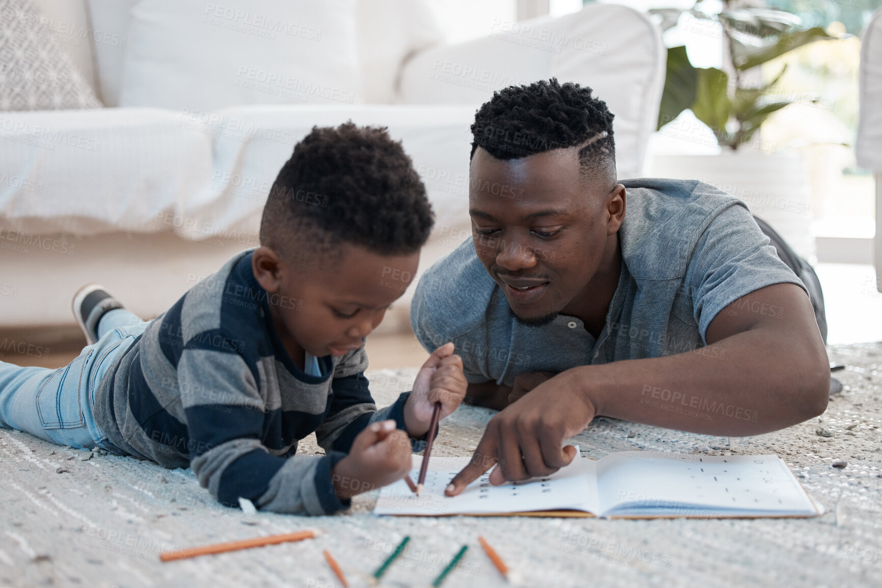 Buy stock photo Dad, kid and help with homework in home for education, learning and support with care. Black parent, school work and teaching for child development or growth with project, art and creativity on floor