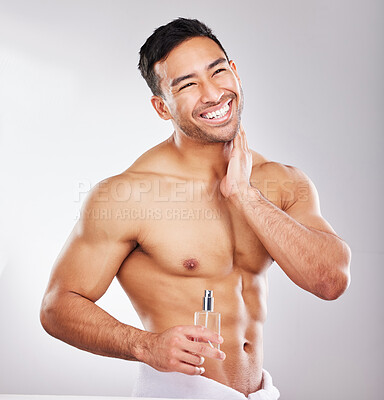 Buy stock photo Happy, man and perfume in studio with skincare or grooming for self care, wellness and natural cosmetics for face. Person, isolated and white background with fragrance cologne for aftershave routine.