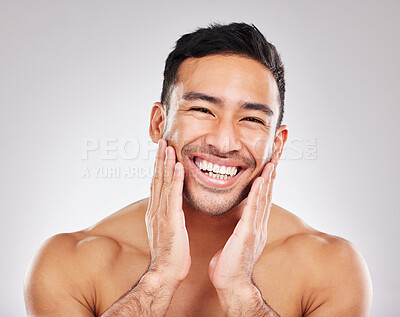 Buy stock photo Cropped studio portrait of a handsome young man posing against a grey background