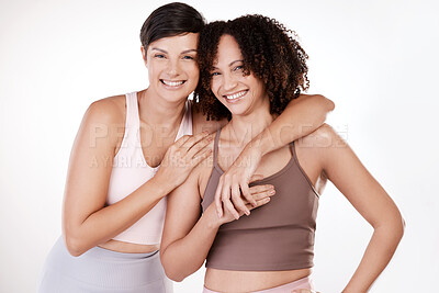 Buy stock photo Cropped portrait of two attractive young female athletes posing in studio against a grey background