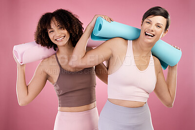 Buy stock photo Cropped portrait of two attractive young female athletes posing in studio against a pink background